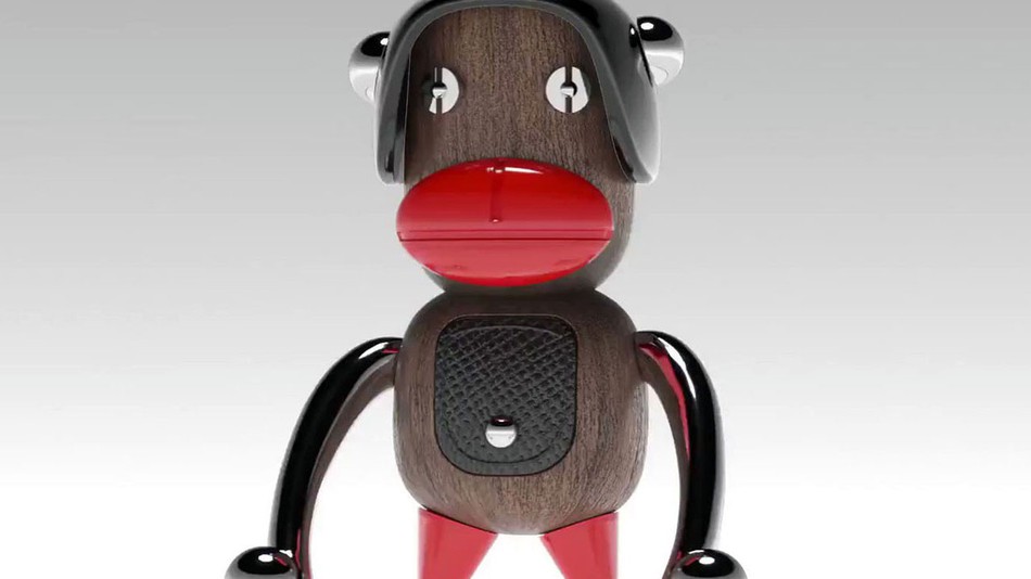 Stylizovaná figurka opičky se sklenými uchy, výraznou červenou tlamou a červenýma nohama
